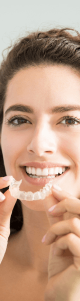 Woman holding invisalign aligners